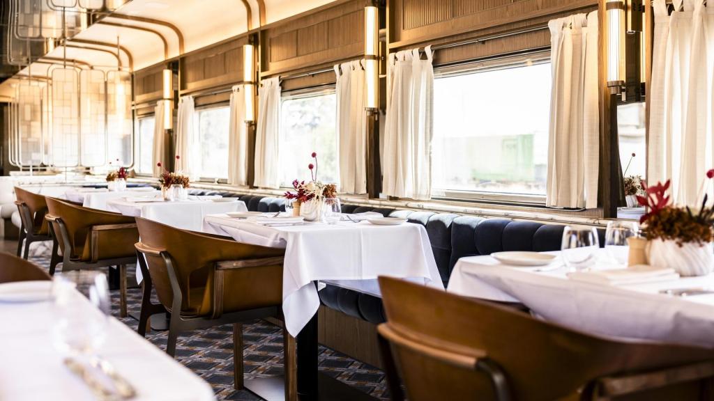 Elegantly set tables and upholstered seats in the Platinum Club dining carriage.